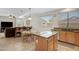 Kitchen/Living Room combination with island sink, eat-in table, and comfortable seating area at 19025 E Raven Dr, Queen Creek, AZ 85142