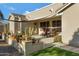 Inviting covered patio featuring comfortable seating and a charming desert-themed decorative retaining wall at 19025 E Raven Dr, Queen Creek, AZ 85142