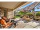 Relaxing covered patio with comfortable seating, a shade and an attractive desert plant display at 19025 E Raven Dr, Queen Creek, AZ 85142