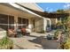 Relaxing covered patio with shaded seating and a beautiful array of cacti and succulent arrangements at 19025 E Raven Dr, Queen Creek, AZ 85142