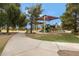 Community park featuring a playground, volleyball court, and scenic walking path at 19025 E Raven Dr, Queen Creek, AZ 85142