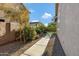 Side yard with walkway and desert-style landscaping at 19025 E Raven Dr, Queen Creek, AZ 85142