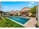 Sparkling backyard pool featuring desert landscaping and a cozy pergola with outdoor seating at 20551 E Mayberry Rd, Queen Creek, AZ 85142