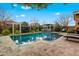 Sparkling backyard pool featuring desert landscaping and a cozy pergola with outdoor seating at 20551 E Mayberry Rd, Queen Creek, AZ 85142