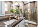 Modern bathroom with double sinks, sleek countertops, custom shower, and bronze hardware at 20551 E Mayberry Rd, Queen Creek, AZ 85142