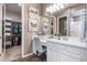 Elegant bathroom with a white vanity, framed mirror and a walk-in closet at 20551 E Mayberry Rd, Queen Creek, AZ 85142