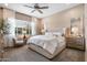 Bright bedroom with carpet, large window, and a plush, upholstered headboard at 20551 E Mayberry Rd, Queen Creek, AZ 85142