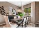 Bright dining room featuring modern chandelier, dark wood table with seating for six, and large window with natural light at 20551 E Mayberry Rd, Queen Creek, AZ 85142