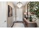 Elegant entryway featuring a chandelier, console table, and neutral decor with a striking leopard print art piece at 20551 E Mayberry Rd, Queen Creek, AZ 85142