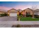 Charming single-story home with a manicured lawn, brick driveway, and attached two-car garage at 20551 E Mayberry Rd, Queen Creek, AZ 85142