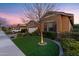 Well-maintained front yard with vibrant green lawn and mature landscaping, framed by a leafless tree at 20551 E Mayberry Rd, Queen Creek, AZ 85142