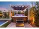 Inviting hot tub with canopy cover and illuminated steps, perfect for relaxation at 20551 E Mayberry Rd, Queen Creek, AZ 85142