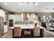 Spacious eat-in kitchen features a large island with white counter and custom light fixtures at 20551 E Mayberry Rd, Queen Creek, AZ 85142