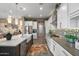 Bright kitchen featuring white cabinets, stainless steel appliances, a kitchen island and stylish lighting at 20551 E Mayberry Rd, Queen Creek, AZ 85142