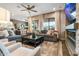 Spacious living room featuring a large sectional sofa, modern ceiling fan, and sliding glass doors to the backyard at 20551 E Mayberry Rd, Queen Creek, AZ 85142