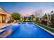 Large pool features water fountains and several pergolas providing shade and lounge seating at 20551 E Mayberry Rd, Queen Creek, AZ 85142