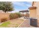 Spacious backyard with grass, pavers, and a pergola, with an AC unit at 2075 S Ponderosa Dr, Gilbert, AZ 85295