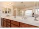 Bathroom with double sink vanity, framed mirrors, and a glass shower with a window at 2075 S Ponderosa Dr, Gilbert, AZ 85295