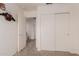 Neutral bedroom with a closet and an adjacent door, with a flight jacket hanging on the wall at 2075 S Ponderosa Dr, Gilbert, AZ 85295