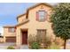 Beautiful two-story home with desert landscaping, neutral color palette, and covered entryway at 2075 S Ponderosa Dr, Gilbert, AZ 85295