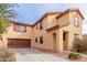 A well-manicured front yard leads to this home's facade and convenient driveway with attached garage at 2075 S Ponderosa Dr, Gilbert, AZ 85295