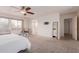 Bright main bedroom offering a relaxing space with a rocker and windows with coverings at 2075 S Ponderosa Dr, Gilbert, AZ 85295