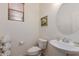 Bright powder room features a pedestal sink, oval mirror, and a window with wood blinds at 2075 S Ponderosa Dr, Gilbert, AZ 85295