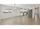 Bright living room featuring natural light, wood-look floors, and an open layout to the kitchen at 21189 E Blue Jay Ln, Florence, AZ 85132