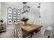 Chic dining area showcases a wooden table with comfortable seating and stylish black-and-white wall art at 21413 N 59Th St, Phoenix, AZ 85054