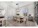 Bright dining room featuring a rustic wood table, modern chandelier, and neutral decor, perfect for Gathering gatherings at 21413 N 59Th St, Phoenix, AZ 85054