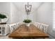 Open dining room boasting a long wooden table and an elegant light fixture, ideal for hosting dinner parties at 21413 N 59Th St, Phoenix, AZ 85054