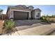 Charming home featuring a two-car garage, brick driveway, and well-maintained landscaping at 21413 N 59Th St, Phoenix, AZ 85054