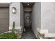 Close-up of the front door and entryway featuring a wreath, stone accents, and landscape at 21413 N 59Th St, Phoenix, AZ 85054