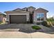 Charming single-story home featuring a desert landscape, paver driveway, and a two-car garage at 21413 N 59Th St, Phoenix, AZ 85054