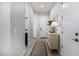 Bright hallway with neutral tones, a decorative console table, and access to other rooms at 21413 N 59Th St, Phoenix, AZ 85054