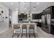 Modern kitchen island with granite countertops, pendant lighting, and stainless steel appliances at 21413 N 59Th St, Phoenix, AZ 85054