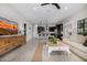 Open-concept living room with a view to the kitchen, featuring neutral decor, and ample natural light at 21413 N 59Th St, Phoenix, AZ 85054