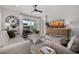 Bright living room featuring a ceiling fan, neutral tones, and a sliding door to the outdoor space at 21413 N 59Th St, Phoenix, AZ 85054