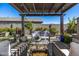 Relaxing outdoor area showcasing a pergola, seating, and manicured landscaping at 21413 N 59Th St, Phoenix, AZ 85054