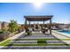 Inviting outdoor living space features a pergola, fireplace, and lush landscaping at 21413 N 59Th St, Phoenix, AZ 85054