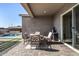 Covered patio featuring outdoor dining set and a glimpse of the pool with a waterfall feature at 21413 N 59Th St, Phoenix, AZ 85054