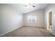 Spacious bedroom with carpeted floors, ceiling fan, window and en-suite bathroom at 24431 N 35Th Dr, Glendale, AZ 85310