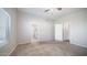 Light-filled bedroom with carpeted floors, vaulted ceiling, and en-suite bathroom at 24431 N 35Th Dr, Glendale, AZ 85310