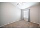 Bright, carpeted bedroom with ceiling fan, large window, and gray curtains at 24431 N 35Th Dr, Glendale, AZ 85310