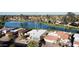 Aerial view of a waterfront residential neighborhood with homes, landscaping, and a serene lake at 26637 S New Town Dr, Sun Lakes, AZ 85248