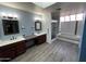 Bathroom featuring double sinks, vanity space, and a separate tub and shower with skylight at 26637 S New Town Dr, Sun Lakes, AZ 85248