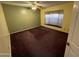 Cozy bedroom with carpeted floor, large window, and ceiling fan at 26637 S New Town Dr, Sun Lakes, AZ 85248