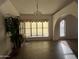 Dining room featuring tiled floors, a large window, and a decorative light fixture at 26637 S New Town Dr, Sun Lakes, AZ 85248