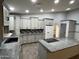 Bright and airy kitchen with grey cabinets, granite countertops, and modern appliances at 26637 S New Town Dr, Sun Lakes, AZ 85248