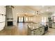 Spacious open living area with wood-look tile floors, stone fireplace, and open layout at 26637 S New Town Dr, Sun Lakes, AZ 85248
